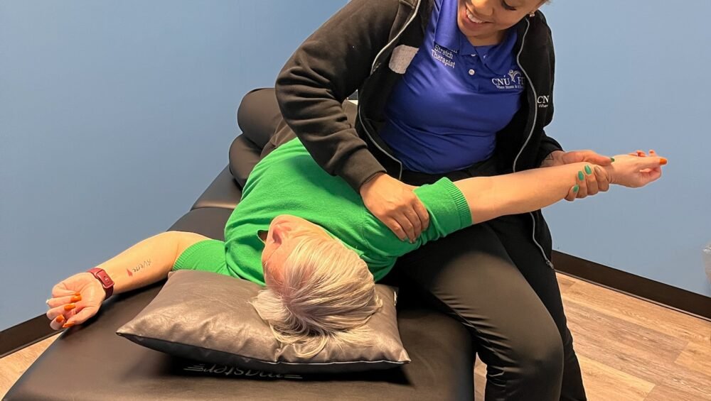 CNU Stretch certified stretch therapist performing assisted stretch session with client