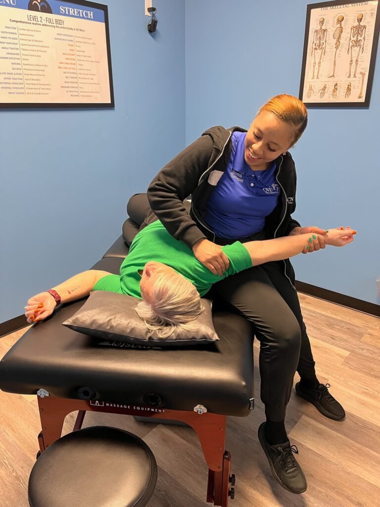 CNU Stretch certified stretch therapist performing assisted stretch session with client