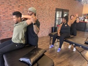 Two men and two women engaged in a stretching session in a wellness studio.